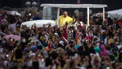 Getty Images Pope Francis greets the crowd from his popemobile following his Mass in Manila in 2015